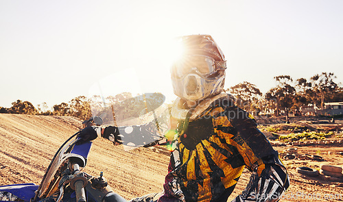 Image of Sports, dirtbike and man in helmet, training and off road riding with desert glare. Extreme transport, bike and gear for motorbike competition, freedom and adrenaline for professional racing male