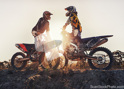 Image of Sport, racer or people on motorcycle outdoor on dirt road with relax after driving, challenge or competition. Sunrise, motorbike or dirtbike driver with helmet on offroad course or path for racing