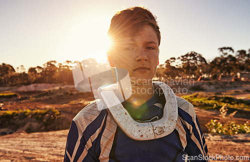 Image of Man, motocross rider or portrait for extreme sport in nature, confident or skill in driving with speed. Man, pride face or gear for motorcycle or off road action or danger with fast vehicle in wood