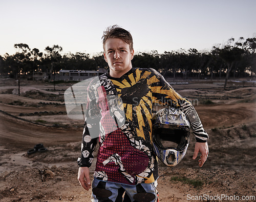 Image of Man, portrait and dessert of professional motorcyclist or dirt bike racer with helmet in confidence for extreme sports. Confident male person, expert or rally rider in dunes for outdoor competition