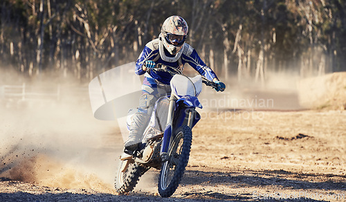 Image of Motorcycle, action and speed with person riding on dirt track, adrenaline and skill for extreme sports outdoor. Competition, adventure and power with risk, fast with biker on motorbike for race