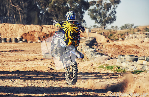 Image of Motorcycle, action and balance, person on race track for adrenaline and stunt with extreme sports outdoor. Competition, adventure and power with risk, biker riding on motorbike with speed and skill