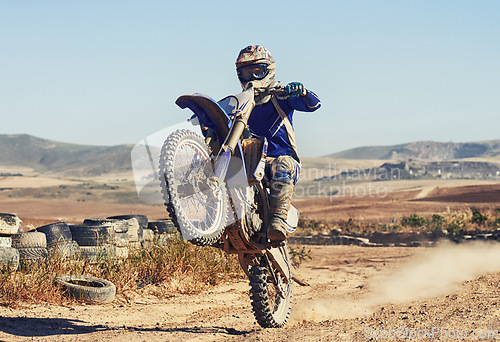 Image of Motorcycle, action and balance of person with speed and skill for adrenaline and stunt with extreme sports outdoor. Competition, adventure and power with risk, biker riding on motorbike with wheelie