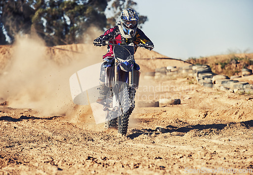 Image of Person, motorcyclist and dust with motorbike on dirt track for race, extreme sports or outdoor competition. Professional or expert rider on bike, scrambler or sand course for off road rally challenge