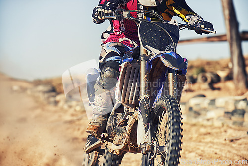 Image of Person, motorcyclist and track with dirt bike for race, extreme sports or outdoor competition. Closeup or legs of expert rider on motorbike, scrambler or sand course for off road rally challenge