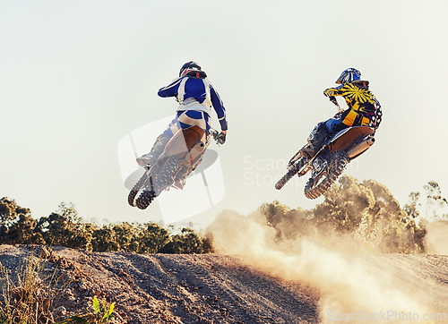 Image of Sport, racer and dirtbike in action for competition on dirt road with performance, challenge and adventure. Motocross, motorbike or motorcycle driver with helmet on offroad course and path for racing