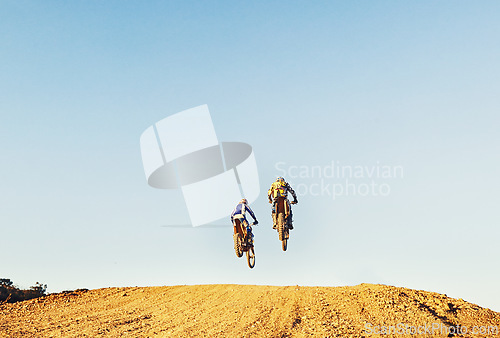 Image of Rear view, racer and motorcycle in action for competition on dirt road with performance, challenge and adventure. Motocross, motorbike or dirtbike driver with jump stunt on offroad course for racing