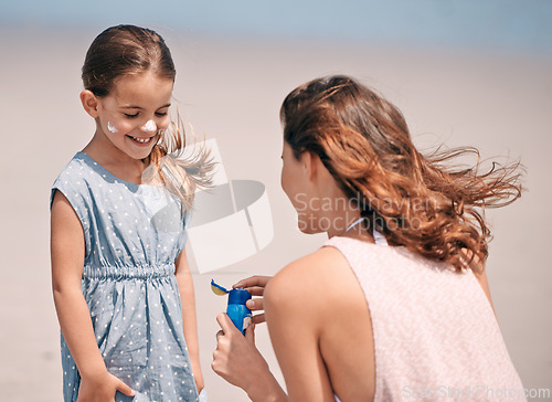 Image of Happy mother, child and sunscreen bottle at beach for summer holiday, vacation or travel. Girl, kid or mom apply sunblock cream outdoor for protection, health or skincare of family together in nature