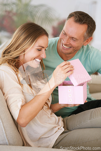 Image of Woman open gift, man and happiness with surprise for birthday or anniversary, love and support with romance. Couple in marriage, unboxing package with ribbon and present for token of appreciation