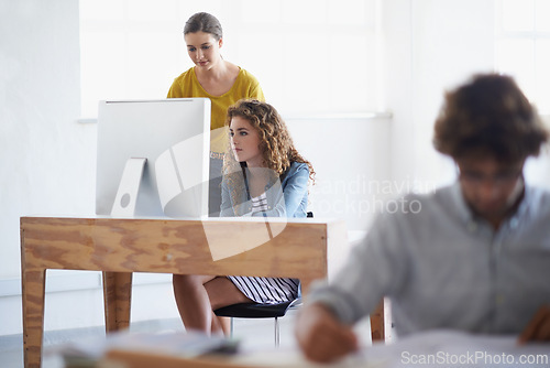 Image of Business women, computer and collaboration in office with online research and connectivity for project in writing. Teamwork, technology or professional in editing or productivity for digital magazine