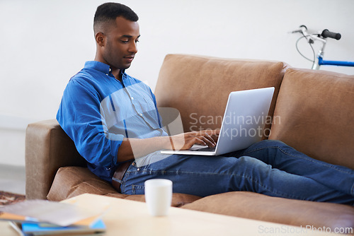 Image of Man, laptop and typing for remote work at home, freelancer and copywriting in living room. Black male person, online and plan on tech or connection for website, information and research for article