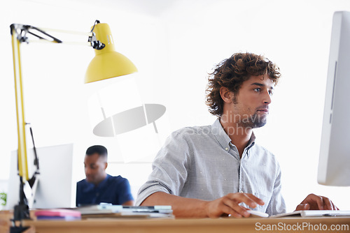 Image of Computer, serious and business man programming, working or planning project in creative startup office. Desktop, professional and developer at table for information technology, software and coding