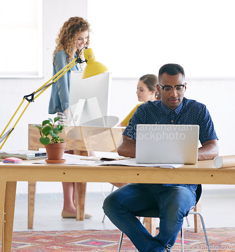 Image of Man, intern and typing on laptop in creative career, working and professional at new job. Male person, journalist and writer for newspaper, online publication and magazine with diversity at workplace