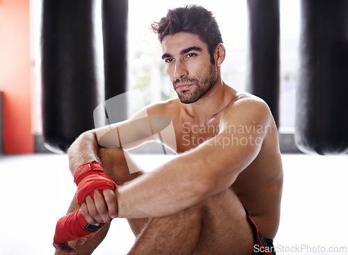 Image of Man, boxer and workout in gym for combat, training and determination with gloves for match. Male athlete, mma and fighter at fitness studio for practicing for competition, challenge and kickboxing