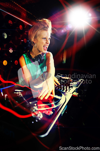 Image of Woman, turntable and music performance in nightclub as dj for dance floor party event, concert or neon lights. Female person, headphones and record scratch or playlist for weekend, track or new year