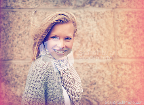 Image of Autumn, fashion and portrait of happy woman in wall, outdoor and brick background. Casual, style and girl with beauty from makeup, cosmetics or positive attitude in city with cardigan and scarf