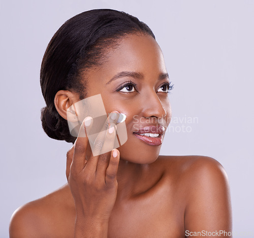 Image of Skincare, cream and black woman for beauty and dermatology, cosmetic product and shine on white background. Self care, lotion or sunscreen for moisturizer, antiaging with skin and facial in studio