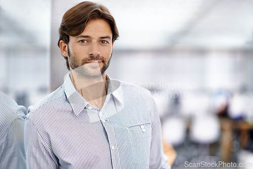 Image of Businessman, portrait and confident in office as professional and happy in career as designer. Male entrepreneur, pride face and commitment to creativity in job and glass for reflection in workplace