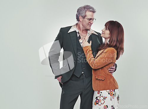 Image of Vintage, romantic and couple together in studio with grey background, retro and love in relationship. Partners, smile and happiness in union of marriage with unique clothes for fashion and style