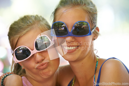 Image of Women, sunglasses and silly portrait at festival in nature, excited and reunion for bonding together. Friends, funny face and relax for celebration in summer on holiday and care at concert outdoor