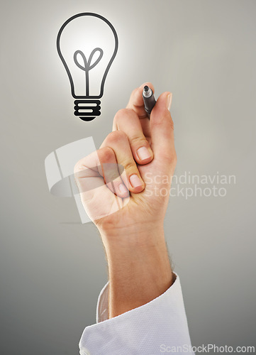 Image of Hand, light bulb and drawing with ideas for business growth and development on grey background. Person brainstorming, corporate innovation and knowledge for enlightenment, inspiration and insights