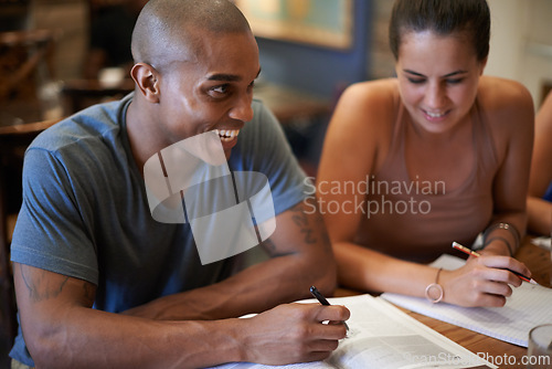 Image of Happy, students and studying for college at cafe with friends and talking about notes in book. University, education and people planning ideas together at coffee shop and planning in conversation