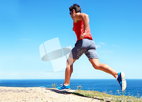 Image of Man, beach and earphones for workout outdoors, jog and athlete for performance training by sea. Male person, full body and back for run in nature, blue sky and listen to music for exercise on mockup