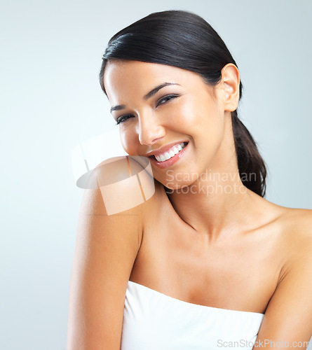 Image of Portrait, woman and smile for skincare, dermatology and microblading on light grey background. Happy, female person and flawless skin for wellness with glow, hydration and body care in studio