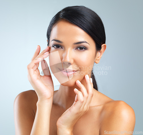 Image of Portrait, woman or hand for skincare, hydration and dermatology in studio on light grey background. Female person, healthy and smile with glow for treatment, facial and self care for flawless skin