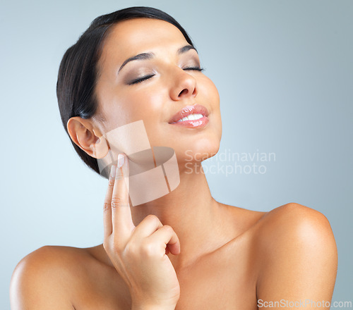 Image of Skincare, shine and woman with cosmetics, wellness and makeup on grey studio background. Person, model and girl with dermatology or glowing with beauty and facial with aesthetic, confidence or health