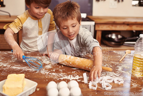 Image of Children, baking and playing in kitchen with ingredients for dessert cake, cookies and fun. Cooking, mess and young brother siblings bonding together for happiness, utensils and smile in house.