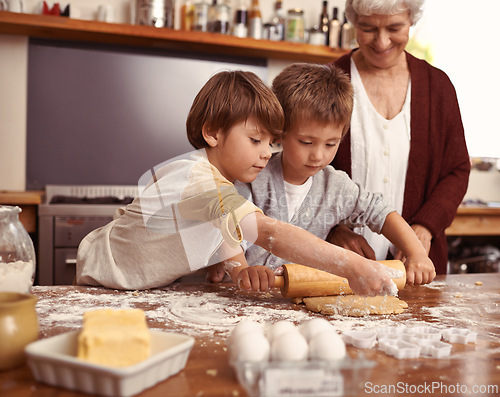 Image of Grandma, smile and children baking in kitchen, learning or happy boys bonding together in family home. Grandmother, kids and cooking with flour, rolling pin or teaching brothers with dough at table