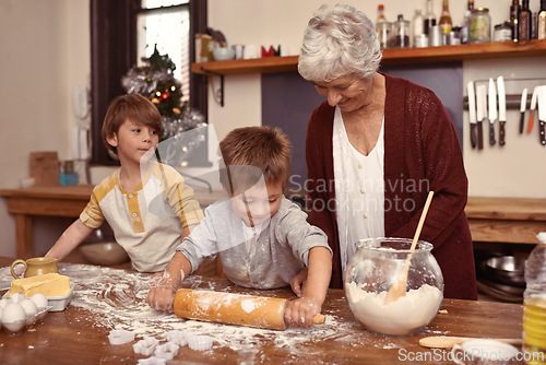 Image of Grandmother, smile and kids baking in kitchen, learning or happy boys bonding together in home. Grandma, children and cooking with flour, rolling pin or messy brothers having fun with family at table