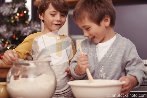 Image of Boys, baking and happy in kitchen with flour, home and learning with ingredients for christmas cake. Children, mixing or bowl for cookies on counter, biscuits or pastry recipe for holiday celebration