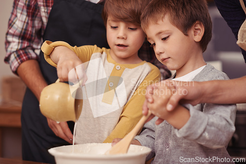 Image of Children, learning or baking in kitchen with ingredients, home or support for dessert cake with love. Happy family, teaching or bowl for cookies on table, care or bonding together on holiday in house