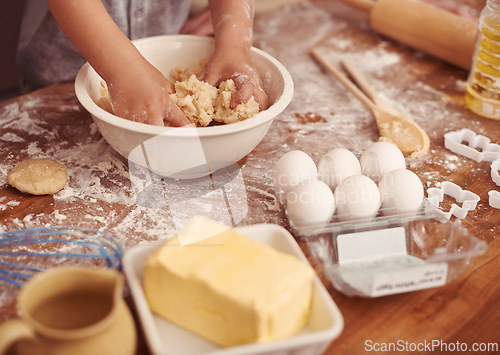 Image of Children, baking and hands in kitchen with dough, home and learning with ingredients for dessert cake. Kids, kneading and playing with flour on table, love and eggs for butter biscuits on holiday