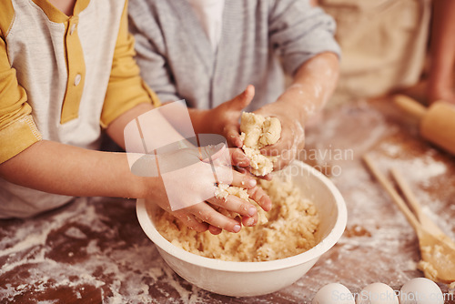 Image of Kids, baking and hands in kitchen with dough, home and learning with ingredients for dessert cake. Children, kneading and playing with flour on table, love and pastry recipe for biscuits on holiday