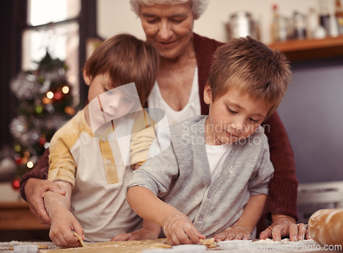 Image of Happy family, biscuits and baking in kitchen with cutter, home and learning of dessert cake with love. Grandma, teaching and boys of cookies on table, care and together on christmas holiday in house