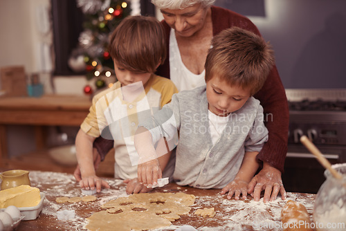 Image of Learning, grandma and children in kitchen baking dessert or pastry. Education, kids and grandmother with cookie dough on table for quality time together in house or holiday, vacation and celebration.