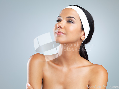 Image of Latina woman, face and skin for beauty, skincare and cosmetics on gray background with glamour, elegance and natural glow. Mexican female person, model and radiance for cleansing, dermatology or care