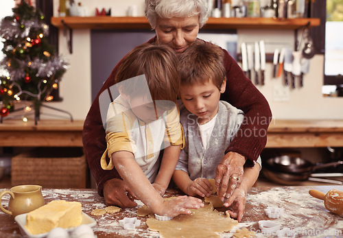 Image of Grandmother, learning and kids baking at Christmas in kitchen, teaching and boys bonding together in family home. Grandma, children and cooking at xmas and brothers making cookies on holiday at table