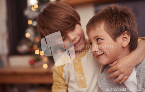 Image of Happy children, hug and together for christmas in home, bonding and playing with love on holiday. Boys, siblings and excited with social or talking, care and embrace for family on vacation in house