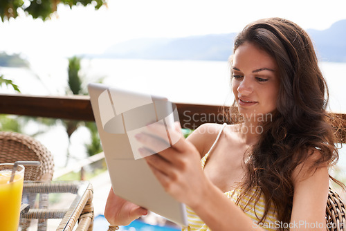 Image of Woman, tablet and holiday for resort, breakfast and swimsuit on vacation while on summertime outdoors. Female person, tech and island with chair to relax on patio, getaway and browsing in Bali