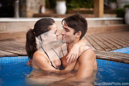 Image of Couple, relax and swimming pool at resort for travel holiday or honeymoon vacation, peace or accommodation. Man, woman and tropical hotel in Hawaii or together for marriage resting, summer or bonding