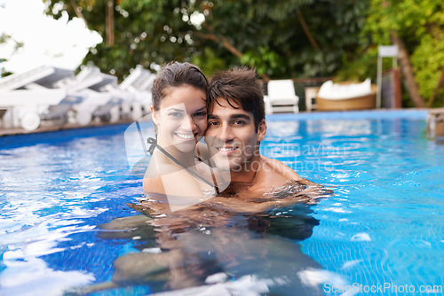 Image of Couple, portrait and resort pool for travel holiday or honeymoon vacation for swimming, relax or accommodation. Man, woman and hotel in Hawaii outdoor together or trip for marriage, summer or bonding