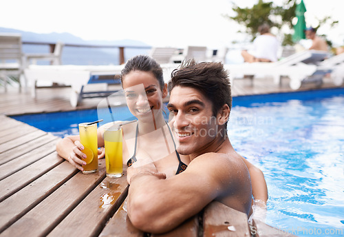 Image of Swimming pool, cocktails and couple with holiday, portrait and weekend break with vacation and honeymoon. Sunshine, man or woman with tropical drink and wet with luxury or summer with love or alcohol