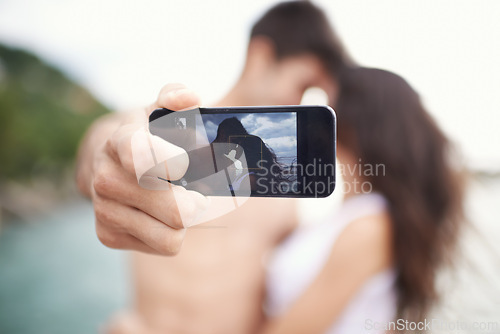 Image of Couple, phone screen and selfie on beach, travel and love on honeymoon vacation. Happy man, woman and cellphone picture for holiday memories, social media and adventure overseas to seaside Bali