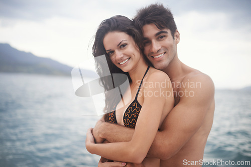 Image of Portrait, smile and couple at ocean for travel, vacation and holiday together outdoor. Face, man and happy woman at sea for adventure, embrace and connection in summer by water in nature for love