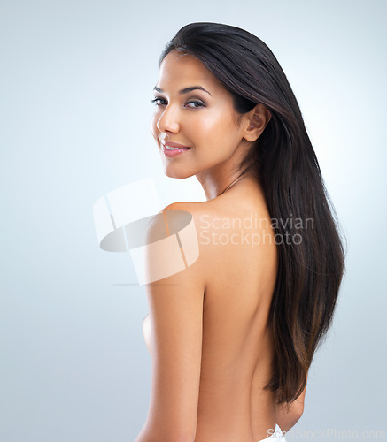 Image of Woman, beauty and hair with shine, portrait of model in studio with cosmetics and keratin treatment on grey background. Haircare, cosmetology and touching skin for wellness with texture and growth