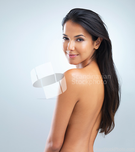 Image of Woman, beauty and hair with cosmetics, portrait of model in studio with shine and keratin treatment on grey background. Haircare, cosmetology and touching skin for wellness with texture and growth